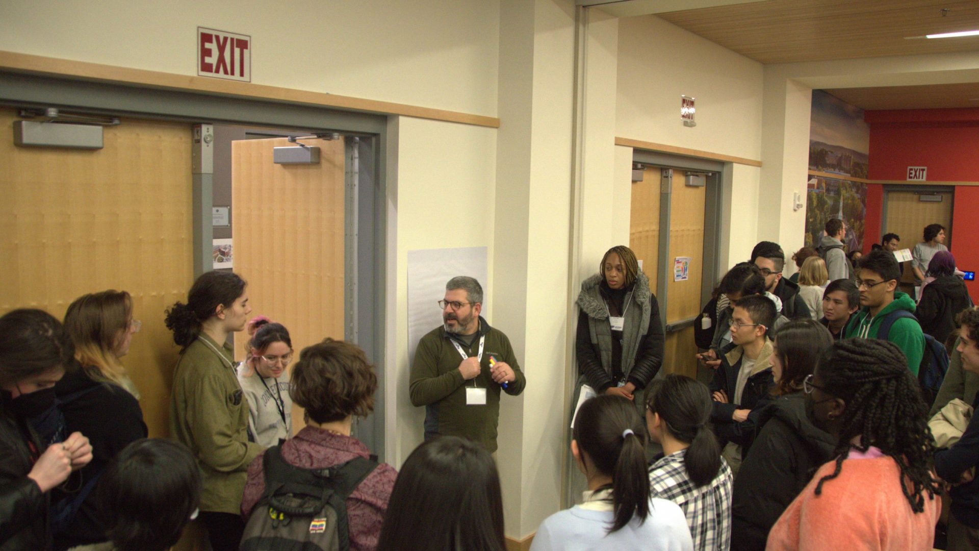 Picture of keynote speaker and mentor Paul Spirito talking with student participants during the Idea Jam.