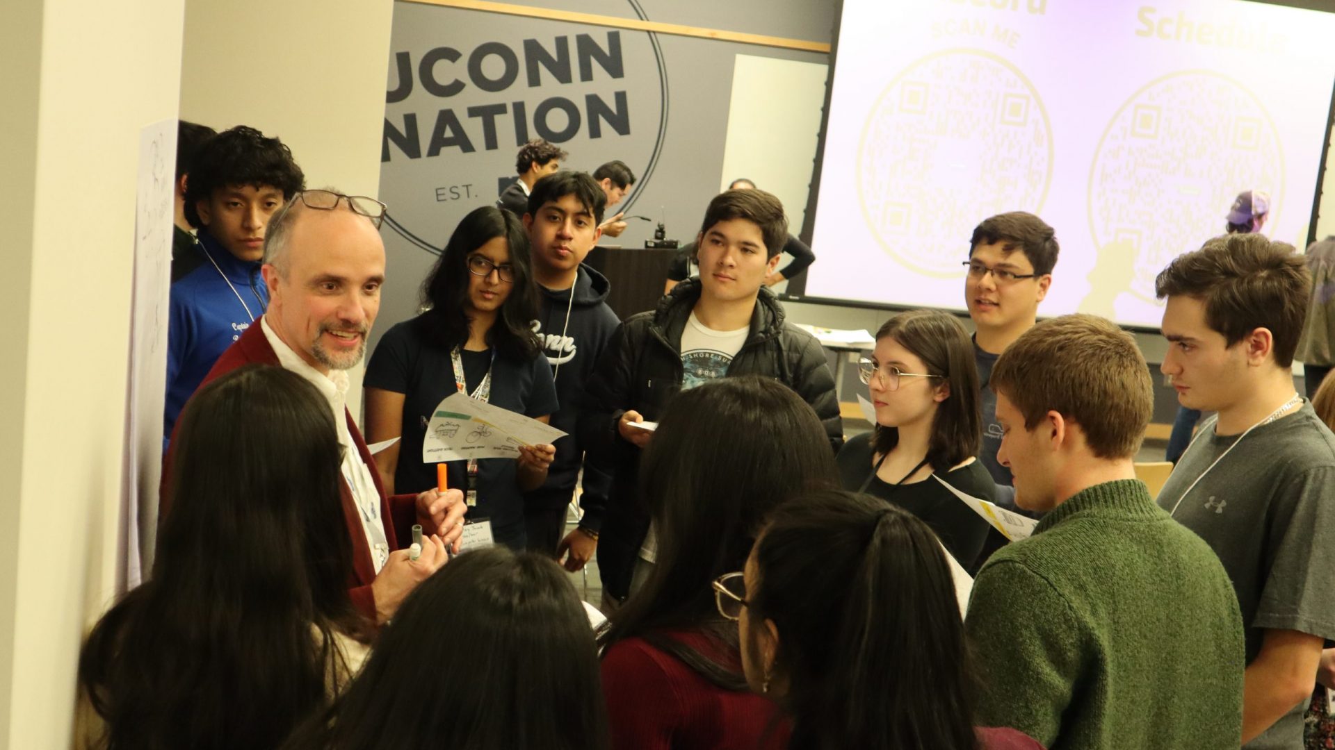 Picture of keynote speaker and mentor Jorge Paricio Garcia talking with student participants during the Idea Jam.
